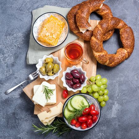 Traditional turkish breakfast with olives, simit bagels, feta cheese, tea, top viewの写真素材