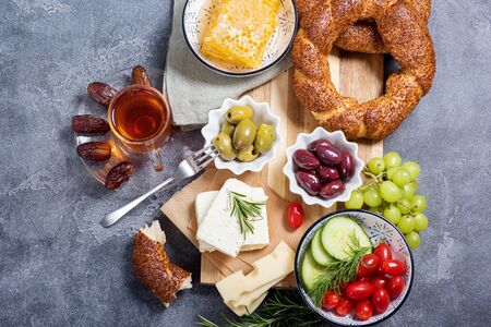 Traditional turkish breakfast with olives, simit bagels, feta cheese, tea with dates, top viewの写真素材