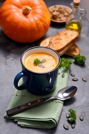 Pumpking soup in a mug, fresh autumn hot soup, homemade healthy soup, cozy food conceptの写真素材