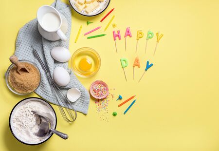 Baking ingredients background for birthday cake on yellow copy space, celebration compositionの写真素材