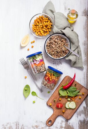 Healthy quinoa mason jar salad with chickpeas and vegetables, detox, diet and clean food concept on white background, top viewの写真素材