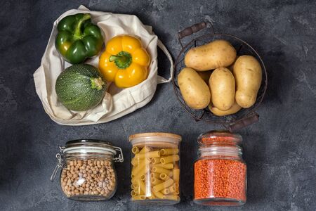 Eco-friendly lifestyle and shopping, zero waste, healthy organic vegetables and food in reusable cotton bag and glass jarsの写真素材