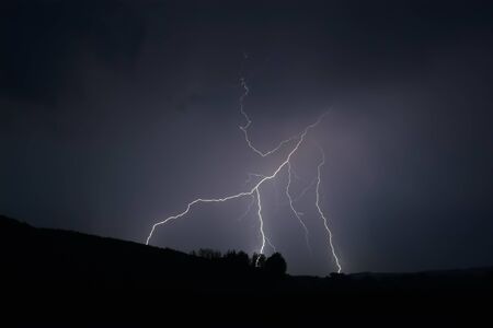 Lightning strike within a thunderstorm at night