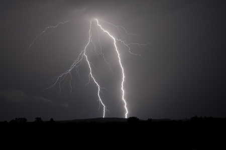 Lightning strike within a thunderstorm at nightの写真素材