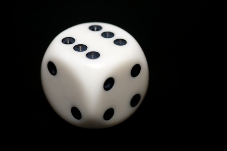 Close-up of a dice with a black background