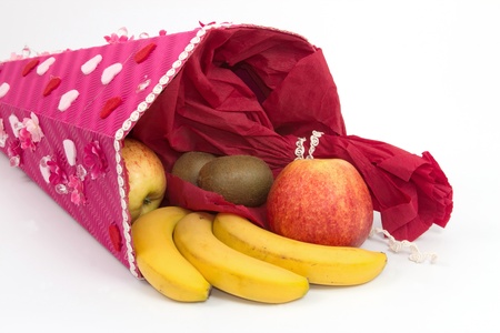 Paper funnel with fruits and a white backgroundの写真素材
