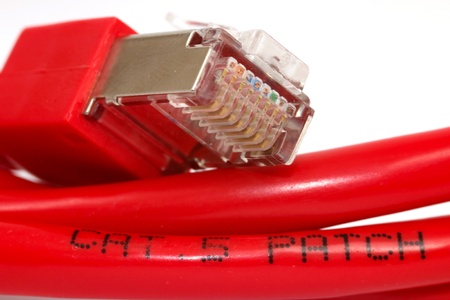 A red network patch cable with a white background
