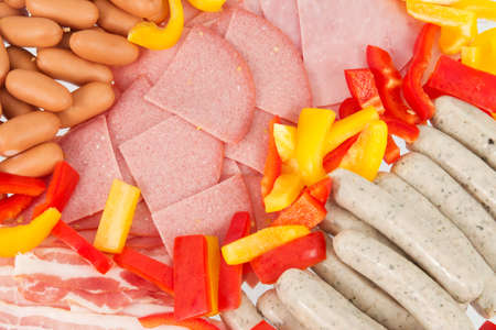 Closeup of different raclette ingredients in front of a white background