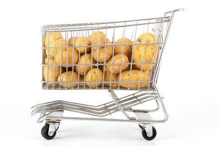 Many potatoes in a cart in front of a white backgroundの写真素材