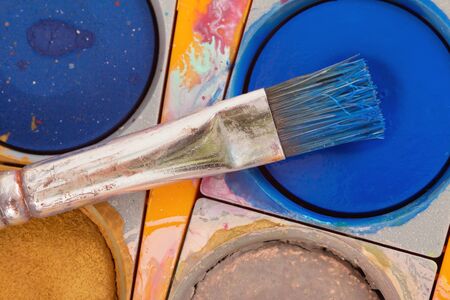 Closeup of a brush on a paintbox