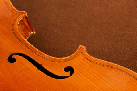 Part of a violin on a brown backgroundの写真素材