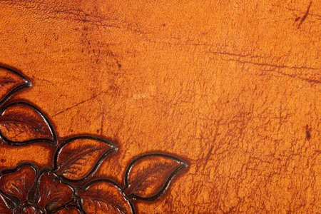 Closeup of orange and brown ornate leather textureの写真素材