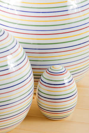 Detail of three Easter eggs on a wooden table