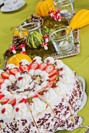 Detail of a table with decoration and a strawberry cakeの写真素材