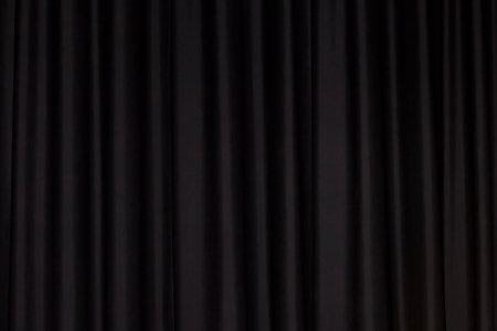 Detail of a black closed curtain in a theatreの写真素材