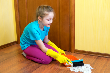 girl sweeping the floorの写真素材