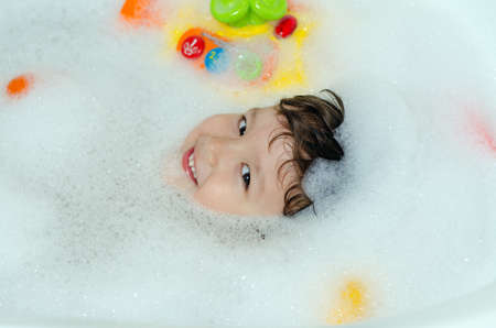 boy bathes in a bathroomの写真素材
