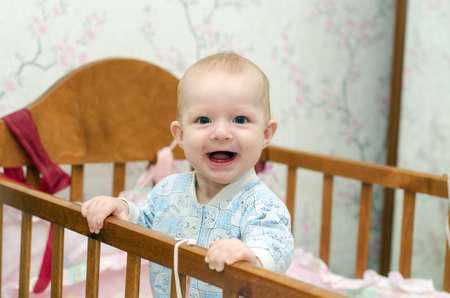 A small child is in a cotの写真素材