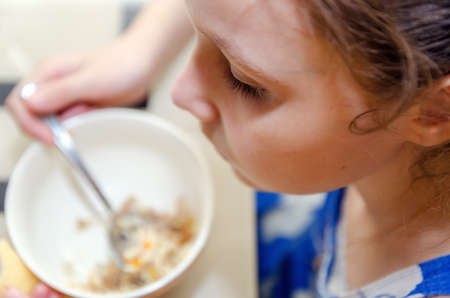 A little girl eats her lunchの写真素材