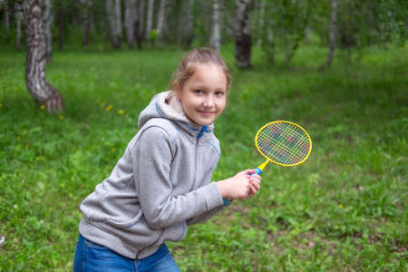 Little girl playing badminton on the streetの写真素材