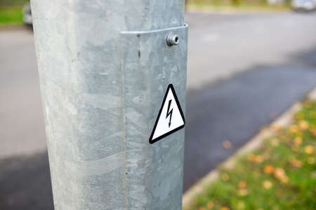 Dangerous electricity sign on the post.の写真素材