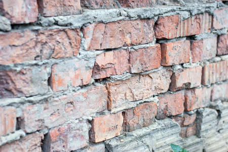 Old brick wall of a village house.の写真素材