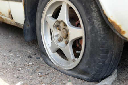 Flat car tire on the road in the city.