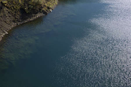 Clear lake at the foot of the mountainの写真素材