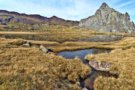 Peak Anayet 2575 m and Vertice Anayet 2559 m at left, in Spanish Pyrenees seen from the Lakes of plateau, partially covered with autumn ice, Aragon, Spainの写真素材