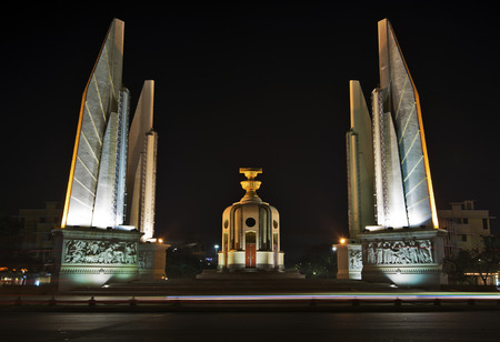 Night view of Democracy Monument in Bangkok, Thailand. The box in the middle Represents the holding...