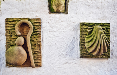 Sculptured symbols of Saint James pilgrimage: scallop shell and Pilgrim's hat. There are symbols of Major Christian pilgrimage route, named one of UNESCO's World Heritage Sitesの写真素材