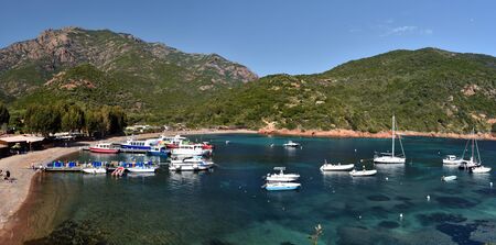 The landscape of Girolata Anchorage with leisure boats and the jetty seen from the village, Corsica Island, Corse-du-Sud, Franceのeditorial素材