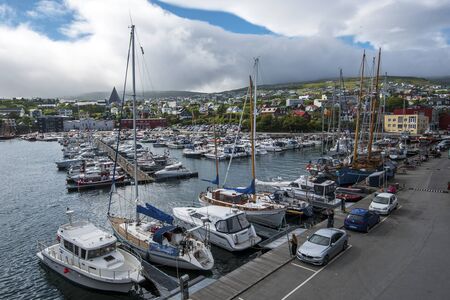 Torshavn, Faroe - July 11, 2018 Vestaravag harbor and Torshavn cityscape, Faroese island of Streymoy