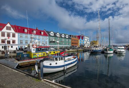 Torshavn, Faroe - July 11, 2018 Vestaravag harbor in Torshavn with its boats, yachts and colorful quayside gabled buildings, Faroese island of Streymoyのeditorial素材