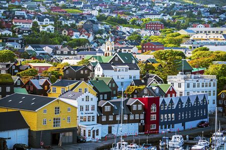Torshavn, Faroe July 11, 2018 Vestaravag bay and Torshavn old quarters with quayside buildings, Faroese island of Streymoyのeditorial素材