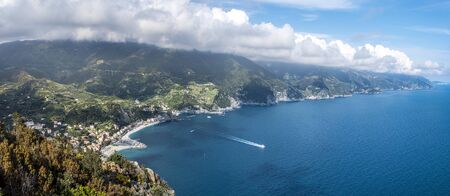 Panoramic view at Cinque Terre coastal area from Mesco Cape. Monterosso al Mare village is at left....