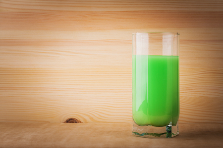 Cocktail green is on an old table. Wooden background.の写真素材