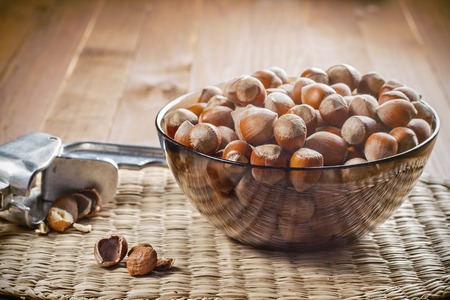 Hazelnuts in a bowl, ready to use. Tool for chopping nuts, woven cloth. Healthy food.の写真素材