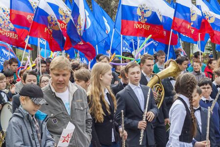 People with the flags of Russia on the march parade May 1, 2016 in the city of Cheboksary, Chuvash...
