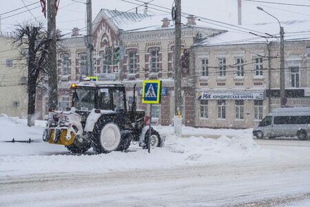 Special technique removes the snow from the street during a snow storm in poor visibility. Snow storm in the city of Cheboksary, Chuvash Republic, Russia. 01/17/2016のeditorial素材