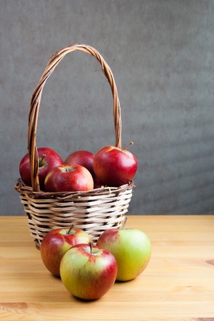 basket with apples costs on table.の写真素材