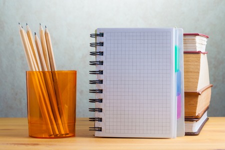 Office supplies are on the table. Notepad with books and pencils.の写真素材