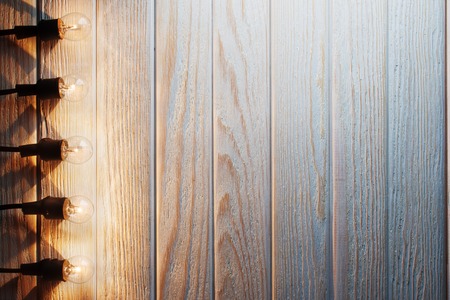 The old light bulbs on a wooden backgroundの写真素材