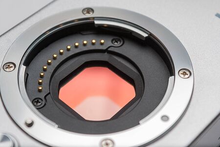 Digital camera sensor. Sensor on a digital mirrorless camera. Glass sensor of digital mirrorless camera and lens mount closeup.の写真素材