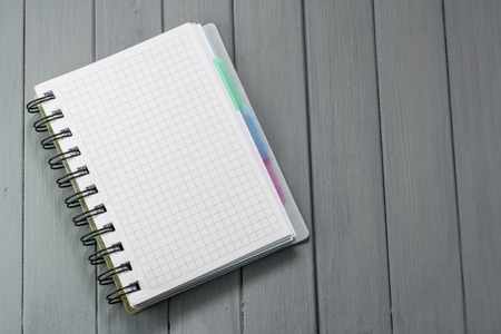 Notepad for recording on a wooden table.