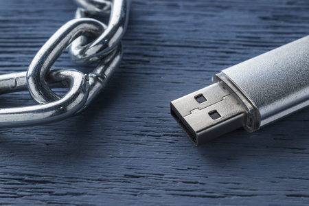 USB flash drive on a wooden background. blockchain