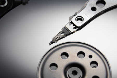 Open hard disk drive. The concept of data storage. Data array. Magnetic head on the surface of the...