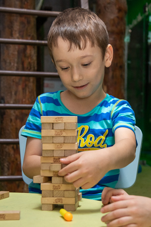 Children play the board game jenga. Cheboksary, Russia, 03/12/2018のeditorial素材