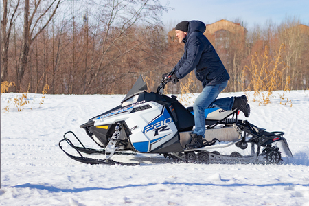 Snowmobile races in the snow. Concept winter sports, racers. City of Cheboksary, Russia, 03/10/2019のeditorial素材