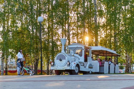 Children ride on the locomotive in the park. Cheboksary, Russia, 28.05.2019